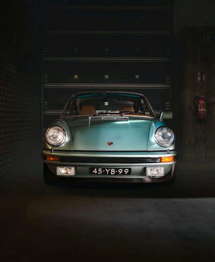 Classic pale-green Porsche in a workshop